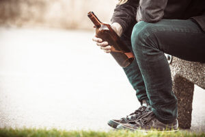 individual with beer bottle has alcohol dependence problem